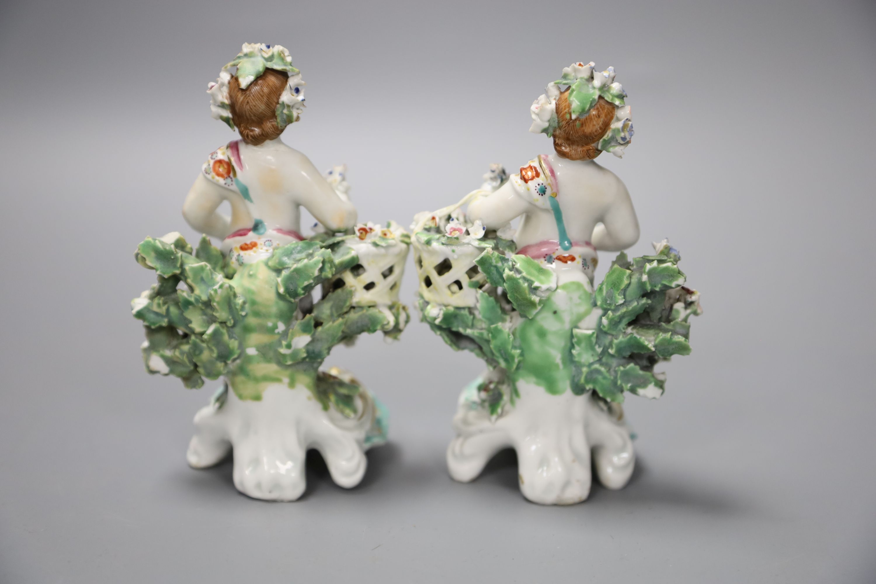 A pair of 18th century Derby figures of children holding baskets, height 12.5cm